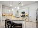 Bright kitchen featuring white cabinetry, granite countertops, stainless steel appliances, and tiled floors at 23703 Waverly Cir, Venice, FL 34293