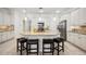 Bright kitchen featuring white cabinetry, granite countertops, stainless steel appliances, and tiled floors at 23703 Waverly Cir, Venice, FL 34293