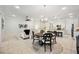 Spacious open-concept living area flowing into the kitchen, with tile flooring throughout at 23703 Waverly Cir, Venice, FL 34293