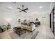 Open living space connecting to kitchen, featuring tile floors and stylish furnishings at 23703 Waverly Cir, Venice, FL 34293