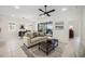 Inviting living room featuring tile flooring, a comfortable sofa, and access to outdoor living at 23703 Waverly Cir, Venice, FL 34293