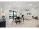 Bright living area with tile flooring, modern lighting, and sliding glass doors to the outdoors at 23703 Waverly Cir, Venice, FL 34293