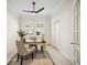 A bright home office featuring white walls, a ceiling fan, and a table in the center of the room at 23703 Waverly Cir, Venice, FL 34293