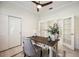 A bright home office featuring white walls, a ceiling fan, french doors, and closet space at 23703 Waverly Cir, Venice, FL 34293