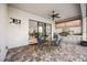 Inviting outdoor kitchen featuring a built-in grill, white cabinetry, brick flooring and seating for four at 23703 Waverly Cir, Venice, FL 34293