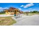 Community park with a building that includes an outdoor BBQ and a shaded playground at 23703 Waverly Cir, Venice, FL 34293