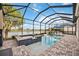 Relaxing pool and spa area with stunning lake views, perfect for outdoor enjoyment at 23703 Waverly Cir, Venice, FL 34293