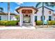 Welcoming entrance to the pool and fitness area with manicured landscaping and elegant architectural details at 23703 Waverly Cir, Venice, FL 34293