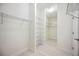 Bright walk-in closet featuring wall-to-wall racks with shelves, and a light wood floor at 23703 Waverly Cir, Venice, FL 34293