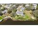 Aerial view of property showcasing home's proximity to waterway and lush surroundings at 2458 Whippoorwill Cir, Sarasota, FL 34231