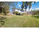 Expansive backyard featuring mature landscaping and plenty of space for outdoor activities at 2458 Whippoorwill Cir, Sarasota, FL 34231