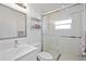 Modern bathroom featuring tiled shower with glass enclosure and a mirrored vanity at 2458 Whippoorwill Cir, Sarasota, FL 34231