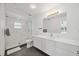 Modern bathroom featuring shower, bath, and floating sink at 2458 Whippoorwill Cir, Sarasota, FL 34231