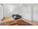 Bedroom features a ceiling fan, a large closet, hardwood flooring, and a sofa at 2458 Whippoorwill Cir, Sarasota, FL 34231
