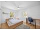 Bedroom has natural light from the two windows, a ceiling fan, and hard wood flooring at 2458 Whippoorwill Cir, Sarasota, FL 34231
