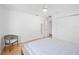 Bedroom featuring a large closet, light hardwood floors, and a grey arm chair at 2458 Whippoorwill Cir, Sarasota, FL 34231
