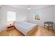 Bedroom featuring a large closet, light hardwood floors, and a grey arm chair at 2458 Whippoorwill Cir, Sarasota, FL 34231