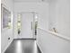 Clean and bright foyer featuring a modern front door and neutral color palette at 2458 Whippoorwill Cir, Sarasota, FL 34231