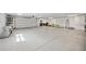 Large two-car garage with ample storage and a roll-up door, ideal for car enthusiasts at 2458 Whippoorwill Cir, Sarasota, FL 34231
