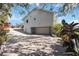 Exterior view showing a two-car garage and long driveway at 2458 Whippoorwill Cir, Sarasota, FL 34231