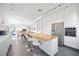 Bright, open kitchen features a large island with seating and stainless steel appliances at 2458 Whippoorwill Cir, Sarasota, FL 34231