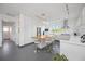 Modern, white kitchen featuring a center island with seating and stainless steel appliances at 2458 Whippoorwill Cir, Sarasota, FL 34231