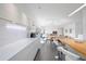 Bright kitchen featuring white cabinetry, center island, and open layout to the living area at 2458 Whippoorwill Cir, Sarasota, FL 34231