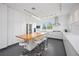 Modern, white kitchen with a center island, stainless steel appliances, and sleek countertops at 2458 Whippoorwill Cir, Sarasota, FL 34231