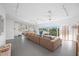 Bright living room featuring a large sectional sofa and floor-to-ceiling windows with outdoor views at 2458 Whippoorwill Cir, Sarasota, FL 34231