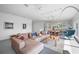 Bright living room features sectional sofa, gray tile floor, and decorative pillows and art work at 2458 Whippoorwill Cir, Sarasota, FL 34231