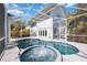 Luxurious pool with attached spa in a screened-in enclosure, offering seamless indoor-outdoor living at 2458 Whippoorwill Cir, Sarasota, FL 34231
