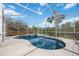 Enjoy this screened-in pool with an integrated spa and beautiful water view at 2458 Whippoorwill Cir, Sarasota, FL 34231