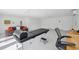 Bright therapy room featuring massage table and sleek gray sofa, bathed in natural light at 2458 Whippoorwill Cir, Sarasota, FL 34231