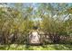 Charming wooden bridge leading to waterway, surrounded by lush greenery and mature trees at 2458 Whippoorwill Cir, Sarasota, FL 34231