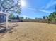 The expansive backyard is mulched and fenced in, ready for landscaping, gardening, or other outdoor activities at 3150 Lake Ridge Dr, Sarasota, FL 34237