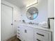 Tastefully designed bathroom with modern vanity, round mirror, and ample counter space at 3150 Lake Ridge Dr, Sarasota, FL 34237