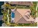 Stunning aerial view of a home with a screened pool, lush landscaping, and a tile roof at 579 Fore Dr, Bradenton, FL 34208