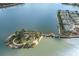 Scenic aerial shot of a lake island connected by a wooden pier to waterfront homes on the shoreline at 6409 Moorings Point Cir # 102, Lakewood Ranch, FL 34202