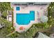 Inviting community pool area, featuring a spacious pool, lounge chairs, and beautiful landscaping at 6409 Moorings Point Cir # 102, Lakewood Ranch, FL 34202