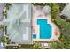Captivating aerial view showcasing a community pool, surrounded by lush landscaping and inviting amenities at 6409 Moorings Point Cir # 102, Lakewood Ranch, FL 34202