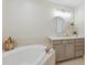 Serene bathroom featuring a soaking tub, single vanity, and neutral color scheme, creating a spa-like atmosphere at 6409 Moorings Point Cir # 102, Lakewood Ranch, FL 34202