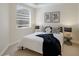 Bright bedroom featuring a large window, neutral walls, and stylish furnishings at 6409 Moorings Point Cir # 102, Lakewood Ranch, FL 34202