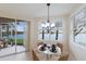 Breakfast nook with lakeside views features modern chandelier and table setting at 6409 Moorings Point Cir # 102, Lakewood Ranch, FL 34202