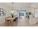 Spacious dining area with lake views, stylish furnishings, and tile flooring at 6409 Moorings Point Cir # 102, Lakewood Ranch, FL 34202
