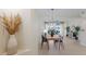 Elegant dining area with a chandelier, lake views, and open floor plan at 6409 Moorings Point Cir # 102, Lakewood Ranch, FL 34202