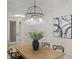 Elegant dining area showcasing a wooden table, unique chandelier, and decorative art at 6409 Moorings Point Cir # 102, Lakewood Ranch, FL 34202