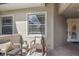 Cozy front porch featuring comfortable seating and a decorative front door at 6409 Moorings Point Cir # 102, Lakewood Ranch, FL 34202