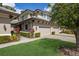Beautiful townhome exterior featuring a two-car garage, and lush landscaping at 6409 Moorings Point Cir # 102, Lakewood Ranch, FL 34202