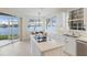 Bright kitchen featuring a central island, stainless steel appliances, and views of the water at 6409 Moorings Point Cir # 102, Lakewood Ranch, FL 34202