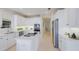 Contemporary kitchen with all-white cabinetry, stainless steel appliances, and lots of natural light at 6409 Moorings Point Cir # 102, Lakewood Ranch, FL 34202